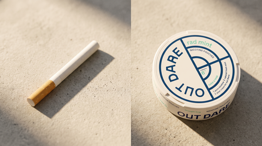 An unlit cigarette lying beside a nicotine pouch can on a pale concrete surface