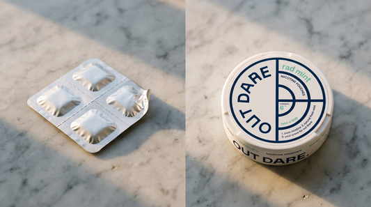 Nicotine gum blister pack lying beside an OutDare nicotine pouch can on a pale marble surface