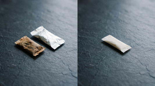 Spent brown snus pouch alongside a clean white nicotine pouch alternative on dark slate