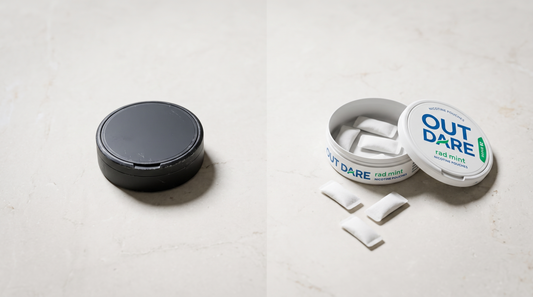 Dark worn round can beside an open white nicotine pouch can showing white pouches on pale stone