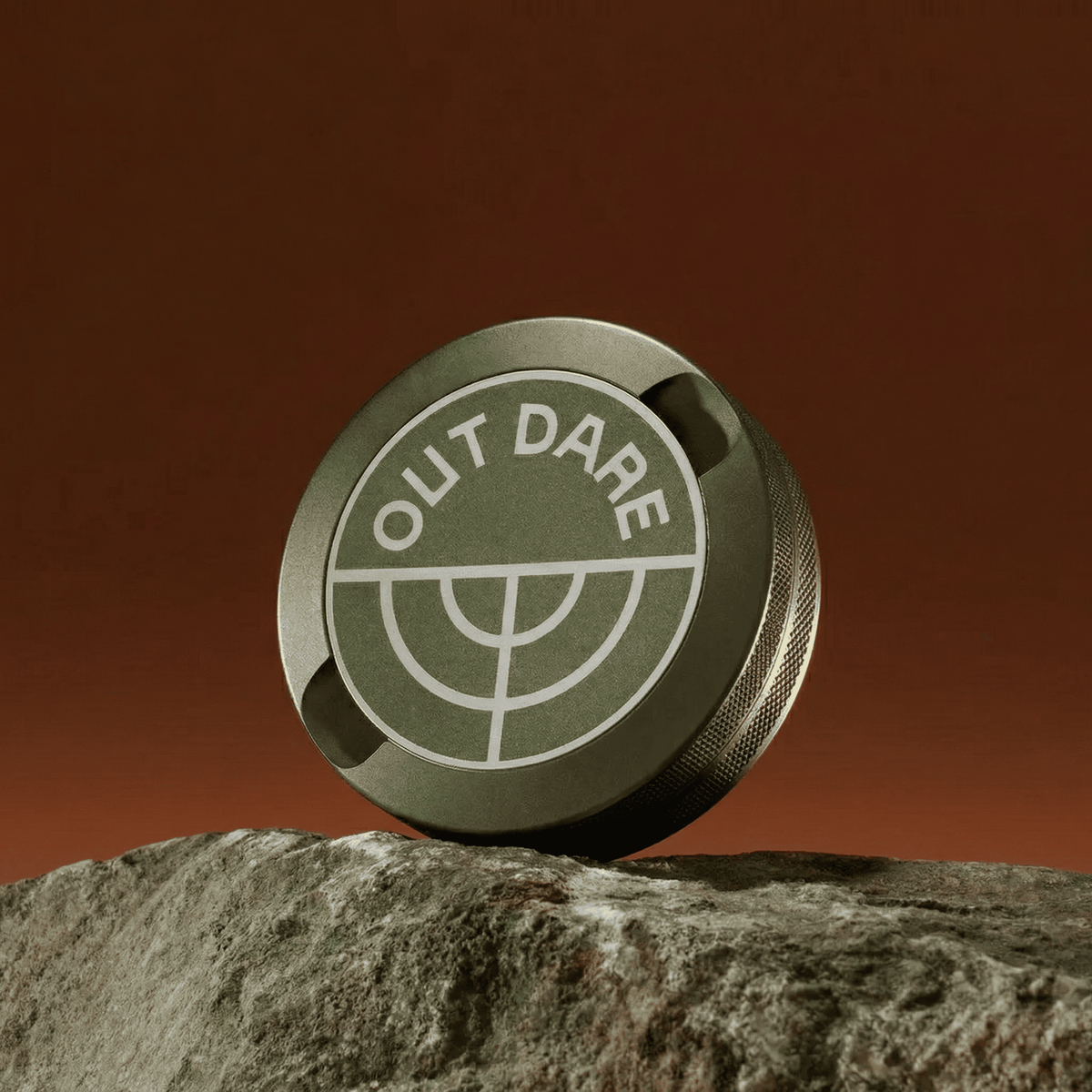 Green OutDare metal can on a rock
