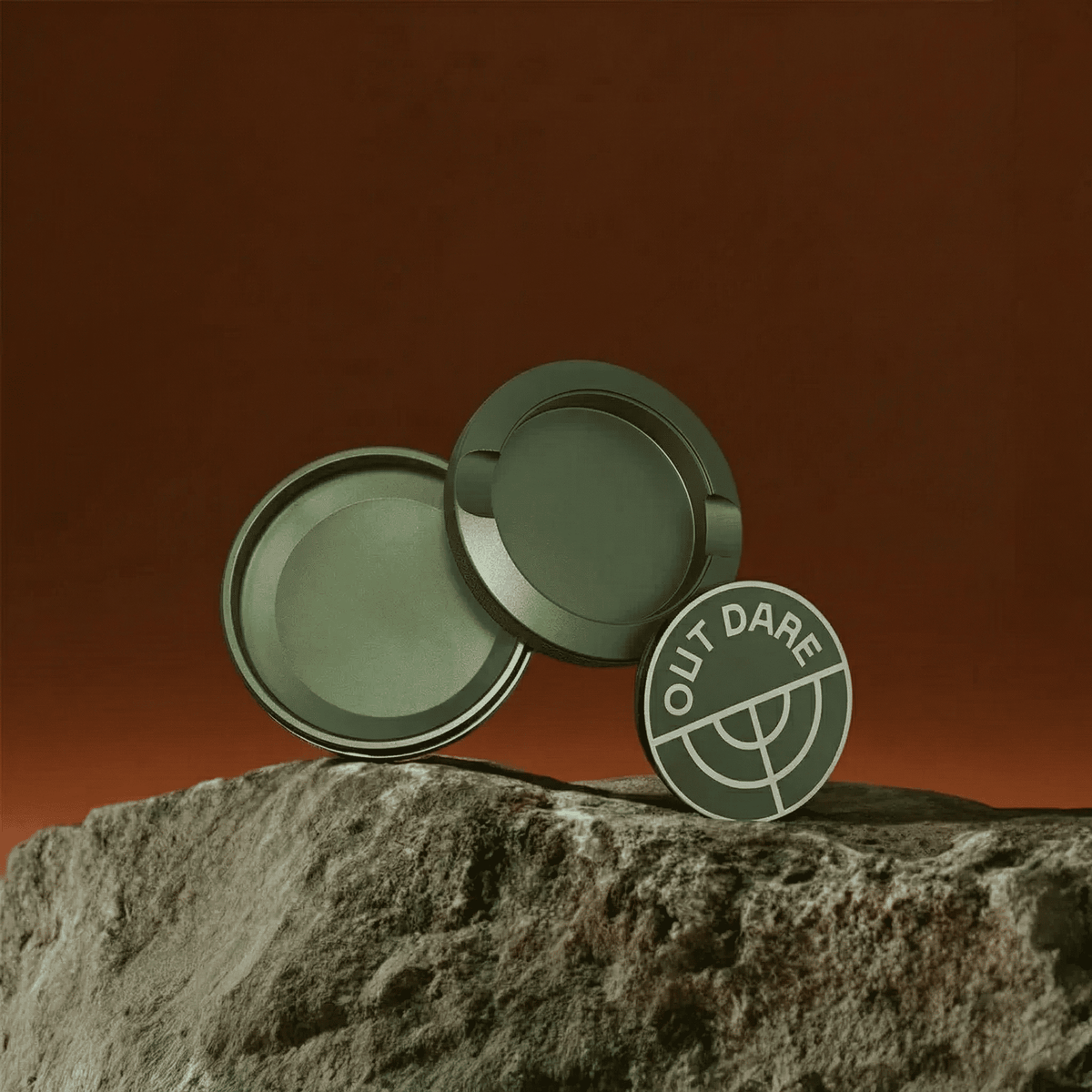 Green OutDare metal can, open, on a rock