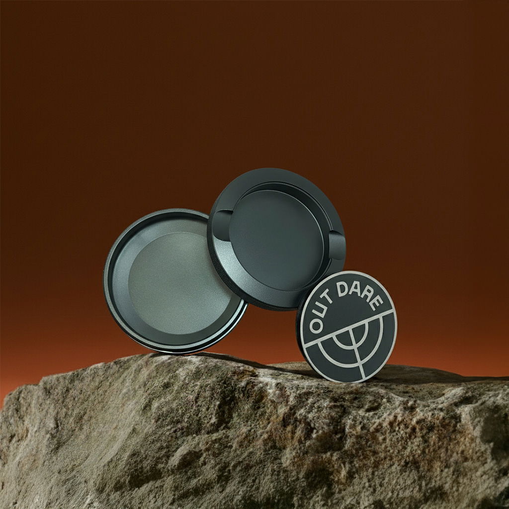 Black OutDare metal can, open, on a rock