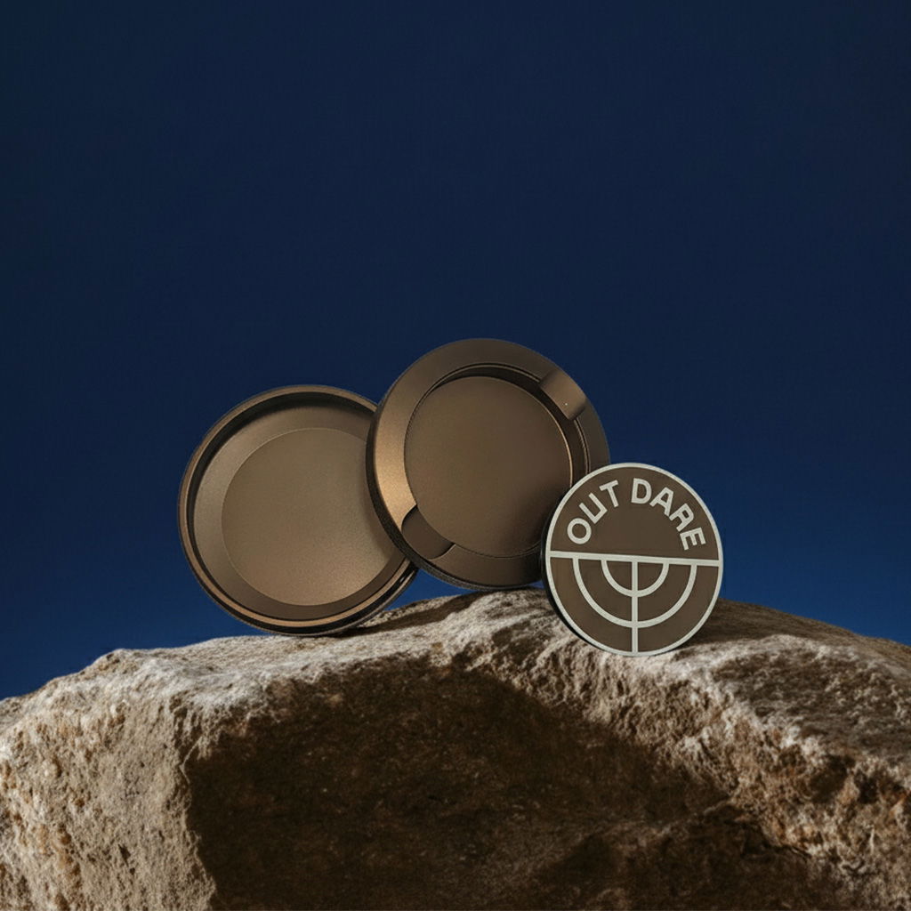 Brown OutDare metal can, open, on a rock against a blue background